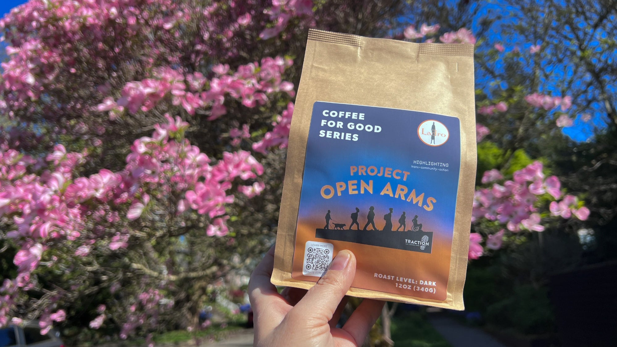 Coffee for Good bag in front of pink flowers