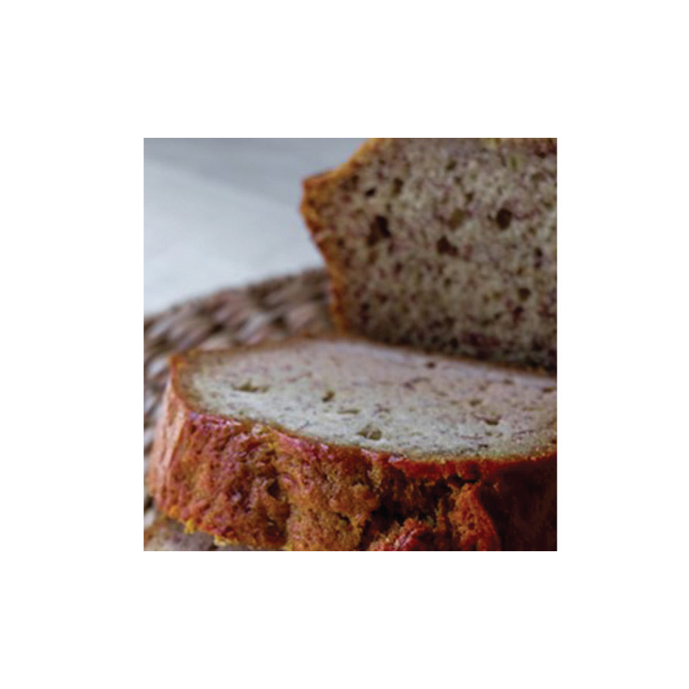 Sliced loaf of banana bread on a white background