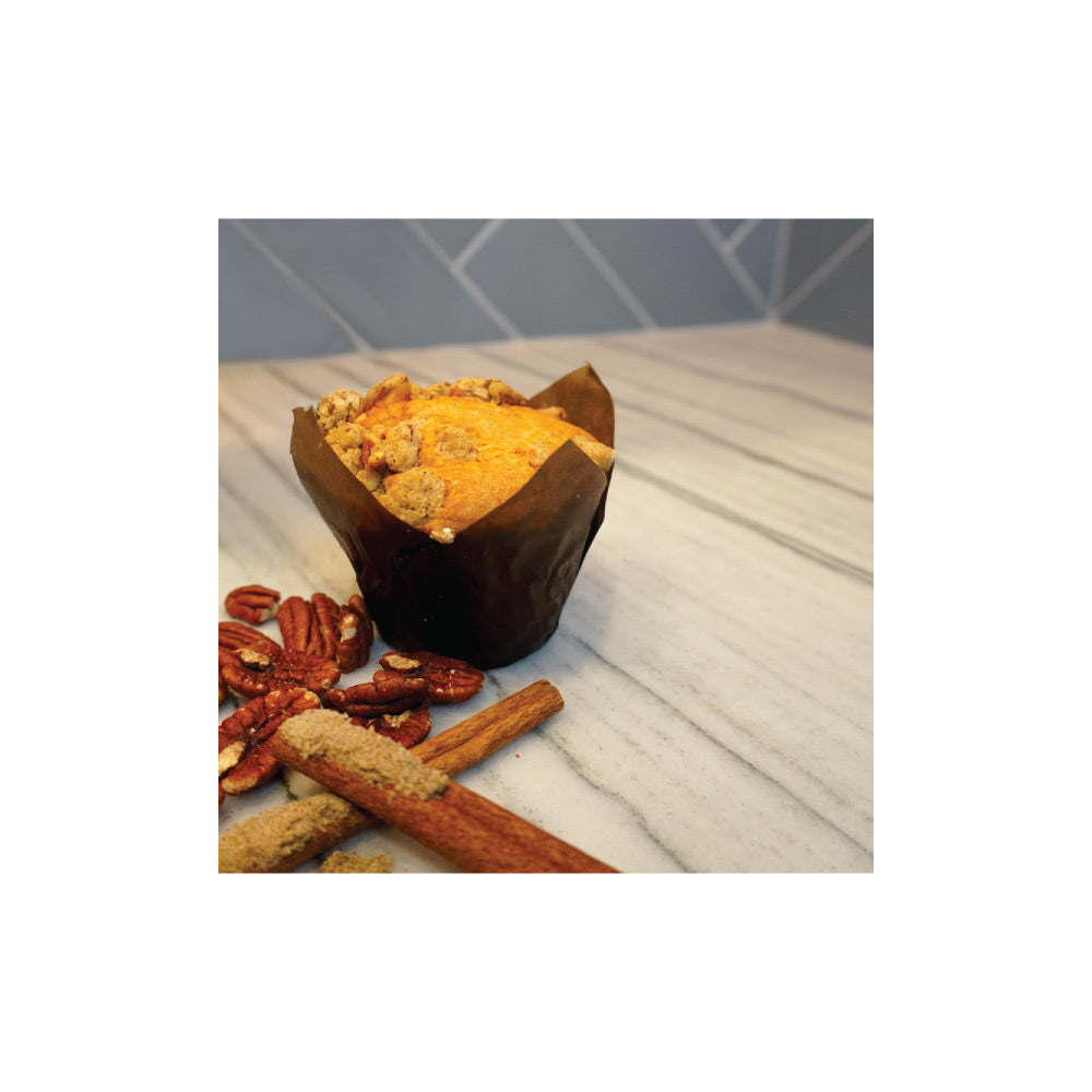 Cardamom muffin with pecans and cinnamon on marble surface