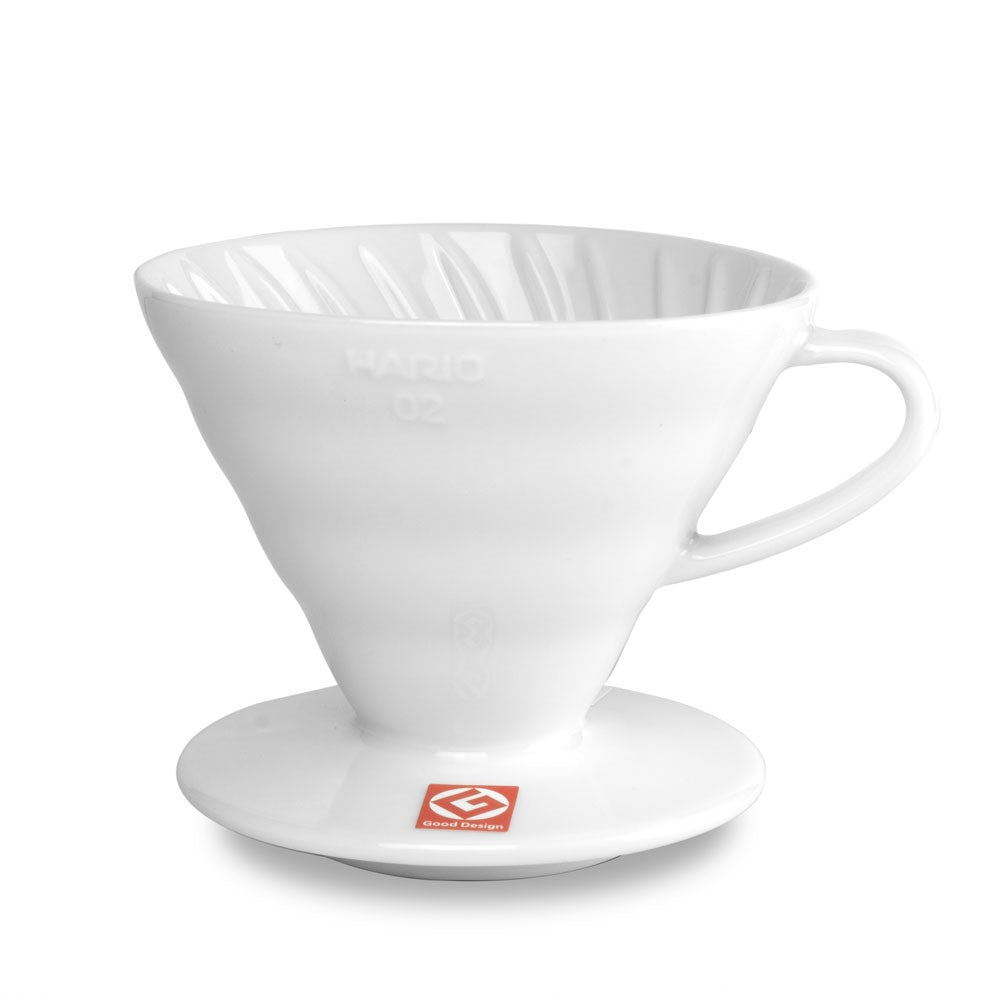 A white Hario V60 ceramic coffee dripper with a conical shape